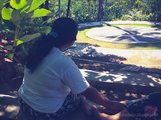 Woman In The Shadow Of The Trees In The Garden On A Sunny Day