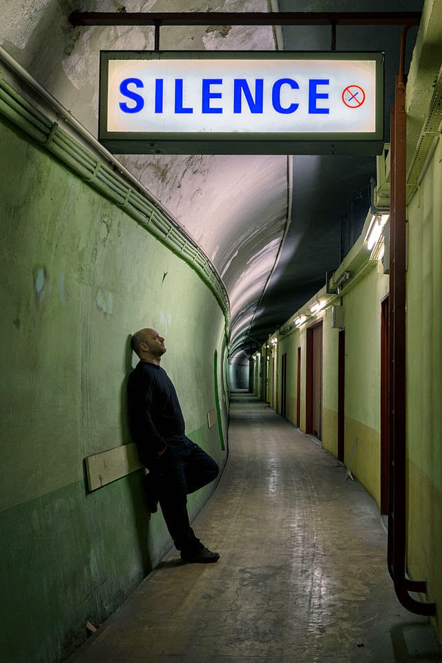 http://commons.wikimedia.org/wiki/Category:Silence_signs#mediaviewer/File:In_an_abandoned_train_tunnel_in_the_Paris_Metro%2C_2014.jpg