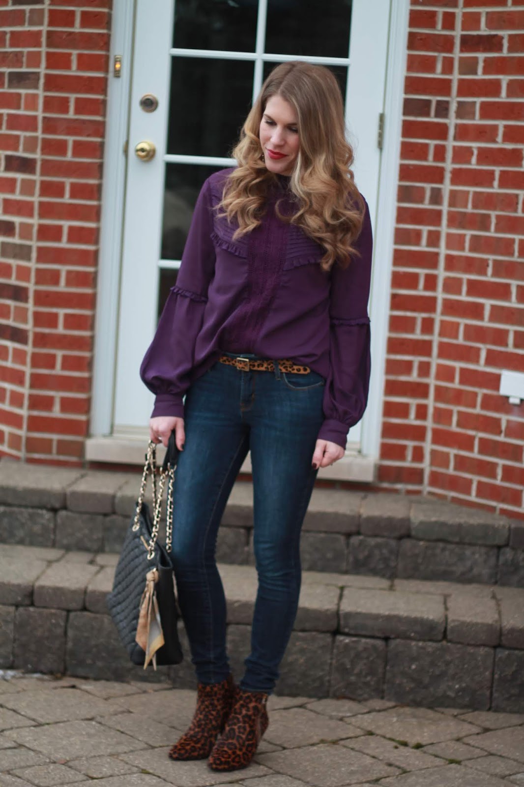purple ruffle blouse, Rockstar jeans, leopard booties, leopard belt, black quilted leather tote