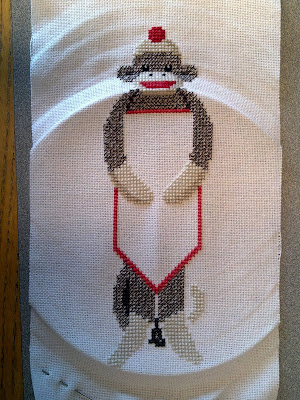 Cross stitched sock monkey - almost done!