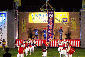 dancing with drums, musicians on stage, pola and village banner