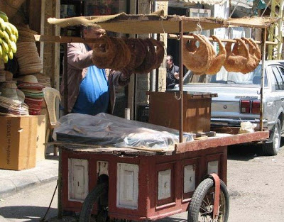 Kaak is a Lebanese street bread, shaped like a purse, coated in sesame seeds, and sold from carts by street vendors.