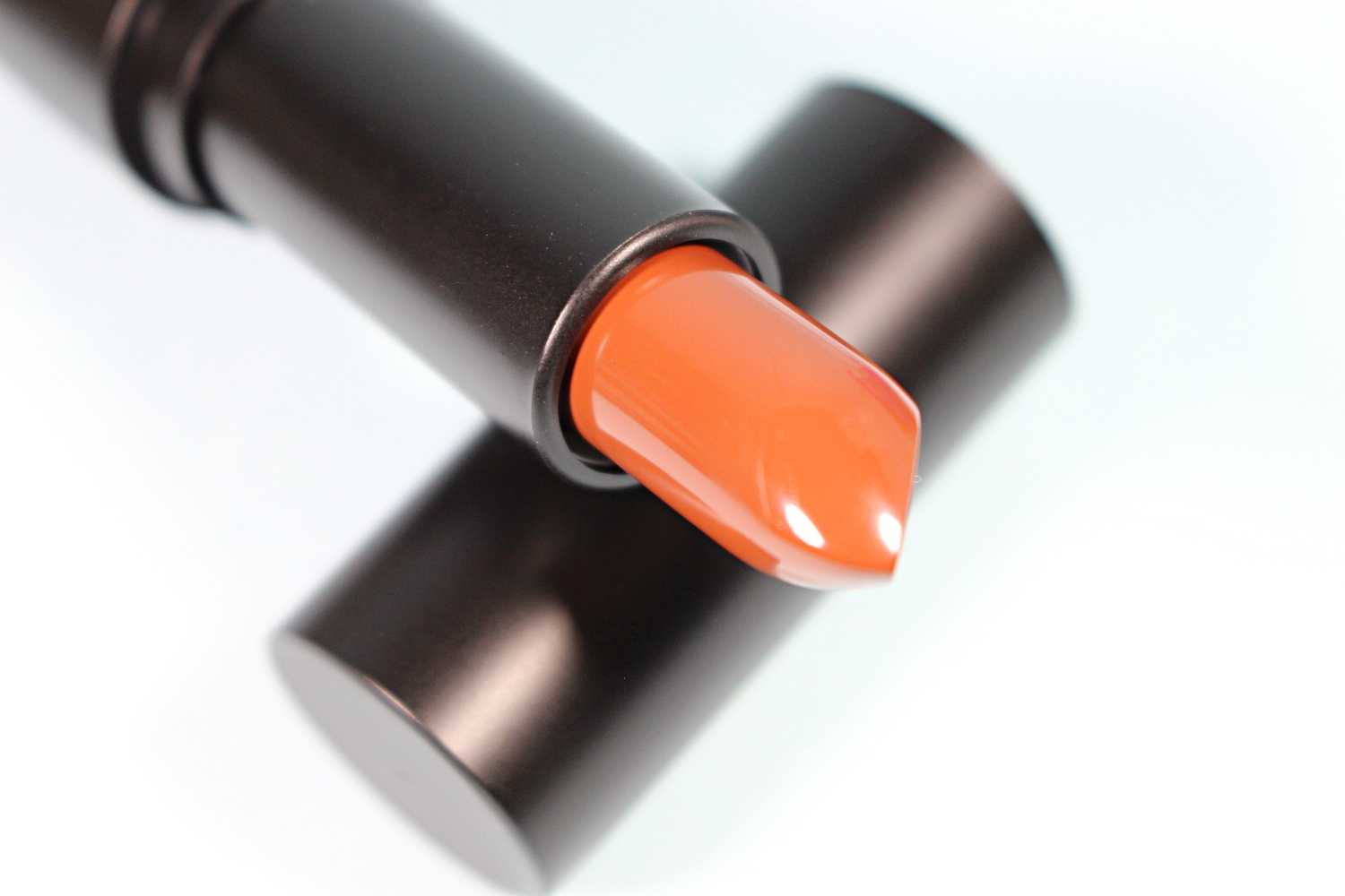 close-up of an opened matte lisptick by city color cosmetics surrounded by makeup products