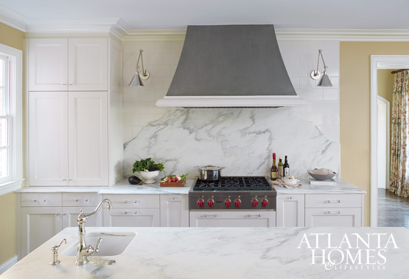 Magnificent white kitchen with marble slab statement wall and island