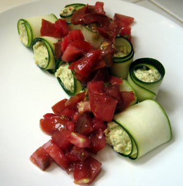 Raw zucchini rolls with cashew cheese and heirloom tomato