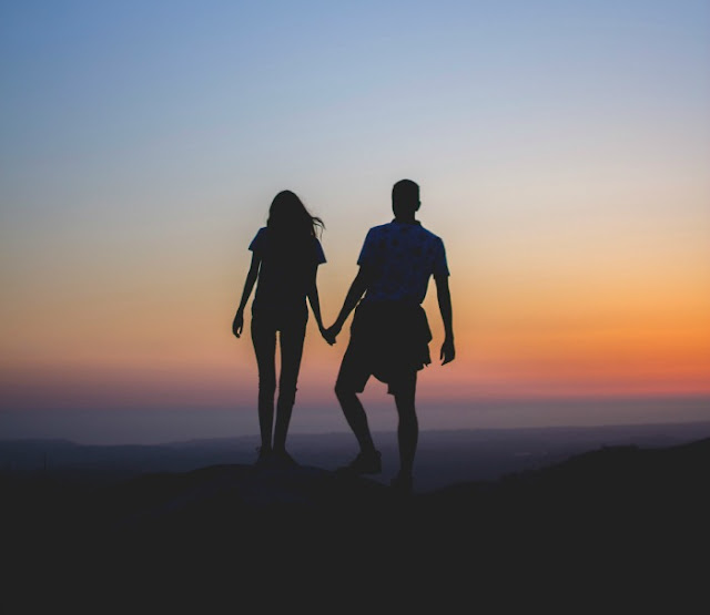 Morgan's Milieu | The Magic of Freedom: A silhouetted couple holding hands at sunset.