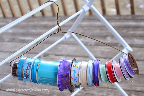 Easy Ribbon Storage Solution: keep spools of ribbon organized with wire hangers. DIY Crafters Crafting Home Organization Tip at directorjewels.com.