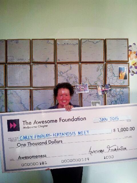 Carly Findlay holding giant cheque from Awesome Foundation