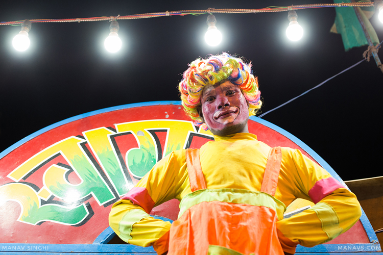 A Guy in the attire of Joker Welcoming to Indian Circus, which was performing on the occasion of Sheetala Ashtami Fair at Chaksu Village, Near Jaipur.