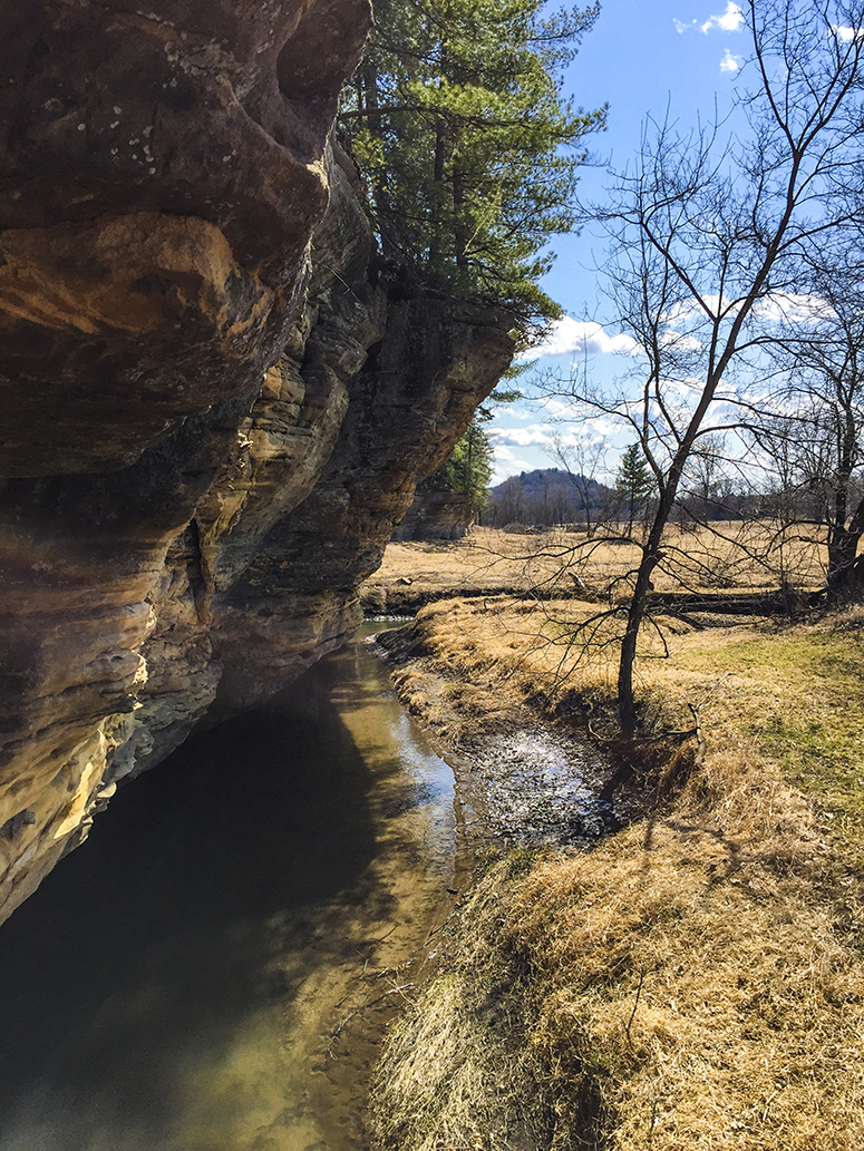 pine river creating a moat at base of sandstone escarpment