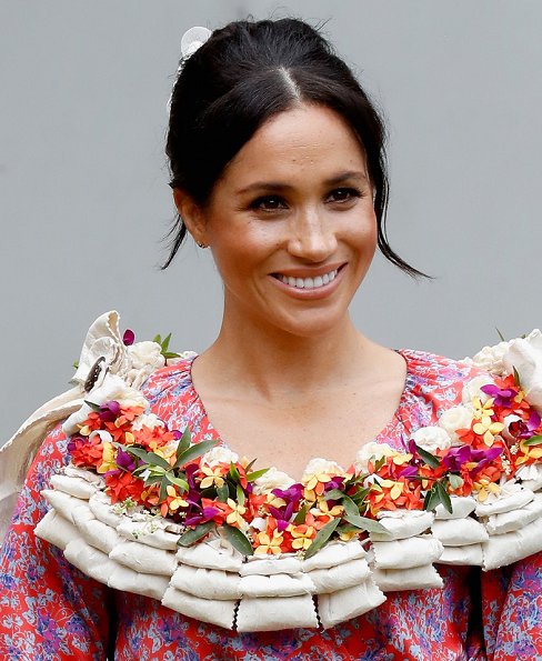 Meghan Markle wore Figue Frederica printed ruffle dress and Castañer Carina Black canvas wedge, and she wore Karen Walker gold stud earrings