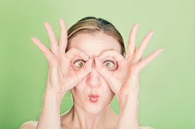 Funny woman using hands as mask, eyes