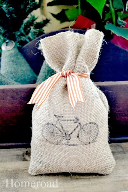 burlap gift bag with orange striped bow and bicycle