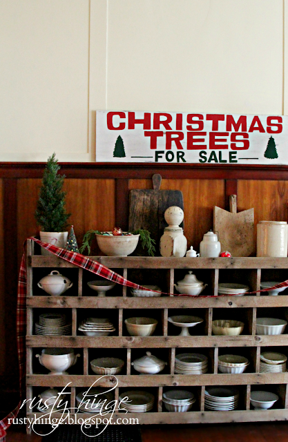 Christmas Trees For Sale sign above chicken nester filled with ironstone