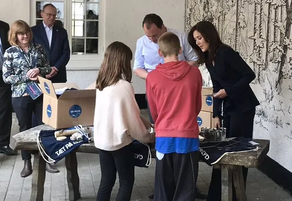 Crown Princess Mary wore Scanlan Theodore crepe knit wrap jacket. and she carries Quidam Alligator clutch at Peter Liep's House