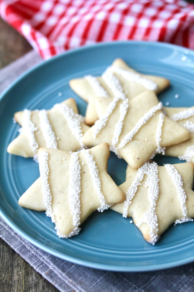 Eggnog Cookies Stars with a glaze and nonpareils on a plate