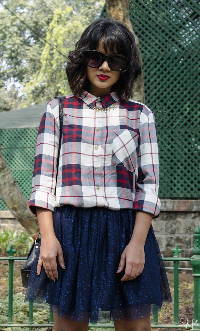 Image of style blogger wearing a plaid checked shirt, tutu skirt, red high heels with a mini bag, red lips and a wavy bob hairstyle