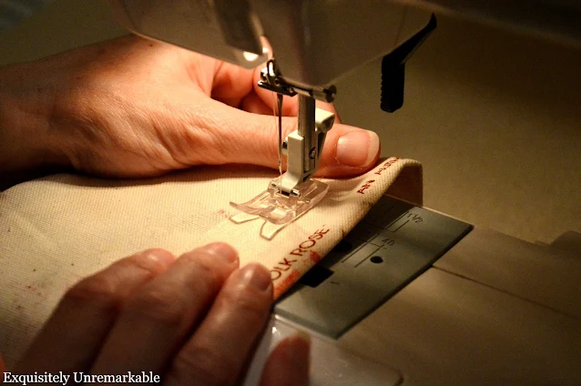 Running fabric through the sewing machine