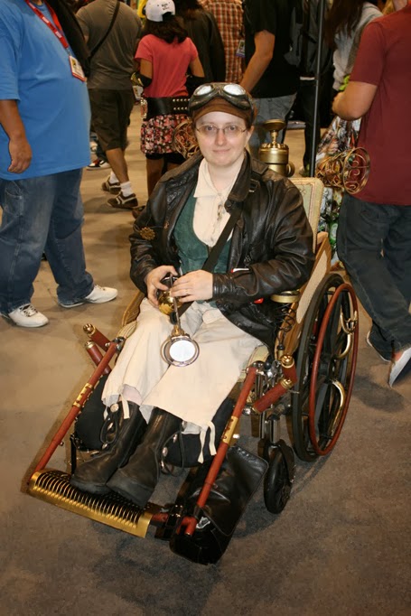 Woman in wheelchair dressed in "steampunk" style, with wheelchair in the same style