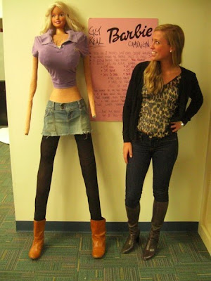 Normal/thin young woman standing next to a disturbingly proportioned homemade mannequin