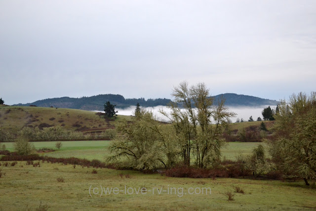 A patch of fog sits in a valley in the distance