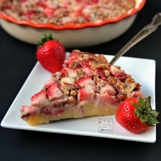 This delicious tart is unbelievably easy to make! Studded with the juiciest strawberries and crunchy pecans and then baked in a sweet vanilla custard batter it's the perfect summer dessert - Strawberry and Pecan Clafoutis | manilaspoon.com