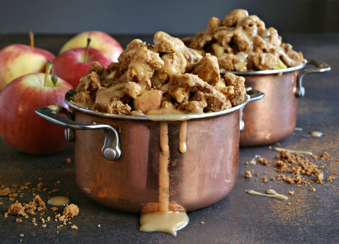 Recipe for an apple dessert baked in individual pots and covered with a peanut butter crumb topping and peanut butter sauce.