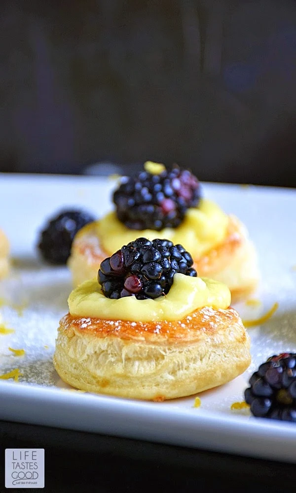Lemon Blackberry Mini Tarts | by Life Tastes Good make an impressive dessert perfect for special occasions, such as Mother's Day. The cutest little pastry puff encases my incredibly easy-to-make Luscious Lemon Curd topped off with a sweet and juicy blackberry. This dessert is sure to brighten your day with the fresh citrus flavors, and you won't believe how easy this gorgeous dessert is to make!