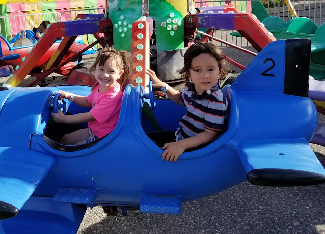 Two little kids Riding at the Fair