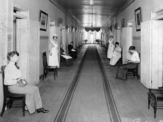 An inside image of Jemison Center or Old Bryce Hospital where people are sitting on chair and nurses standing