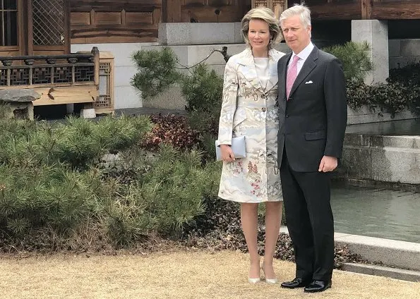 Queen Mathilde wore a green floral print coat by Emporio Armani, and Dries Van Noten grey satin floral coat, Armani bag and Armani pumps