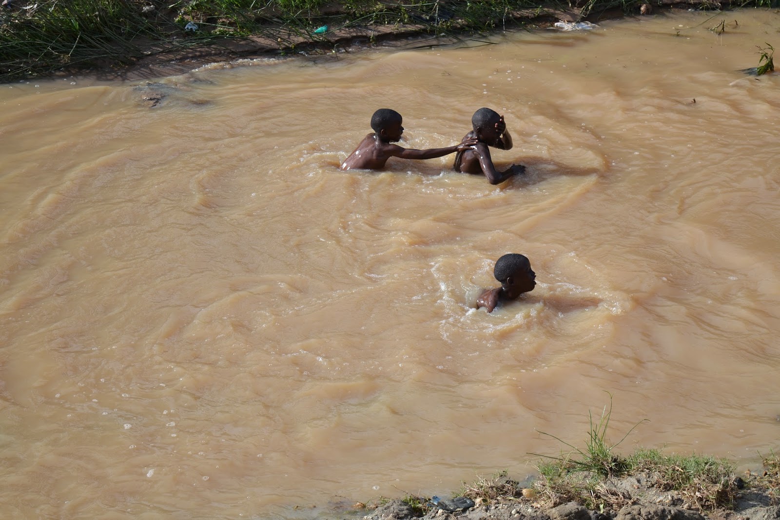 Health Matters Children Swimming in contaminated and dirty water in a