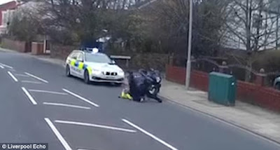 Motorcyclist beating and punching a Policeman as he is straddling him on the ground, in Liverpool.