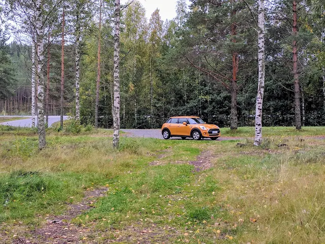 Yellow mini car at a rural rest stop on a Southeastern Finland road trip itinerary