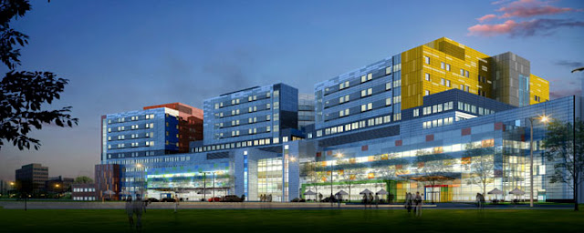 Rendering of McGill University Health Centre's Glen Campus at sunset with blue, red and yellow colors on the facade