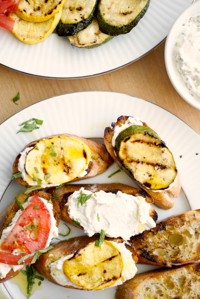 This Grilled Summer Squash and Tomato Crostini is the perfect summer appetizer featuring garden-fresh summer squash, tomatoes, and a Parmesan-herb cream cheese layered on a garlic toasted baguette.