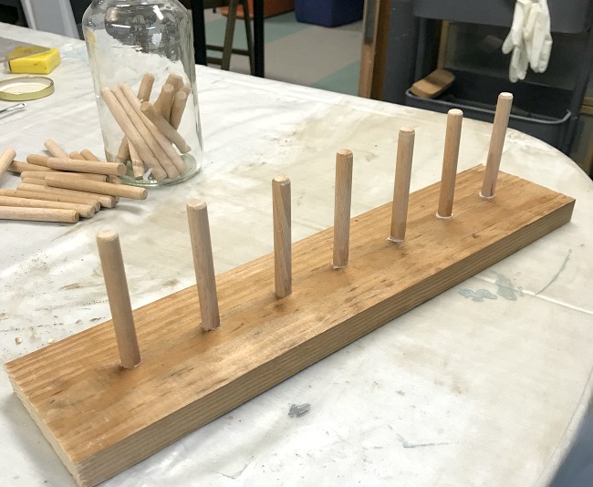 DIY Reclaimed wood and wooden dowel pegs for twine organization