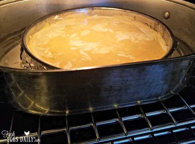 cheesecake in water bath in oven
