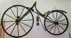 1800s bicycle hanging on wall