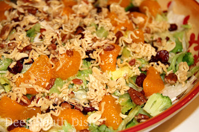 Anything and Everything Salad - a mixture of lettuces and various toppings, here topped with broccoli, bacon, mandarin oranges, dried cranberries, dressed with a sweet and sour dressing and topped with a buttery almond, pecan and ramen noodle crunch.
