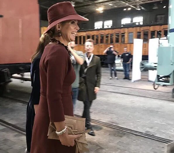 Queen Maxima wore Natan burgundy belted midi dress, and Delvigne hat, Natan pumps