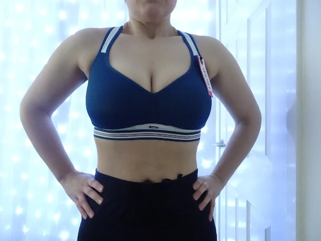 woman standing in blue sports bra 