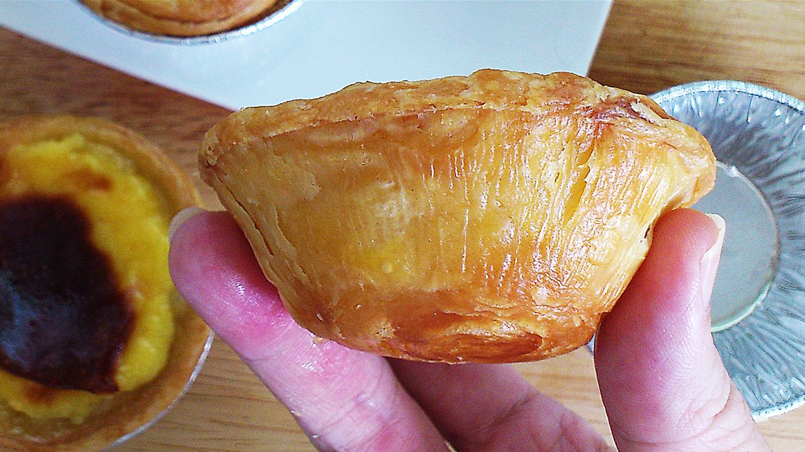 sliced portuguese egg tart showing smooth and creamy custard