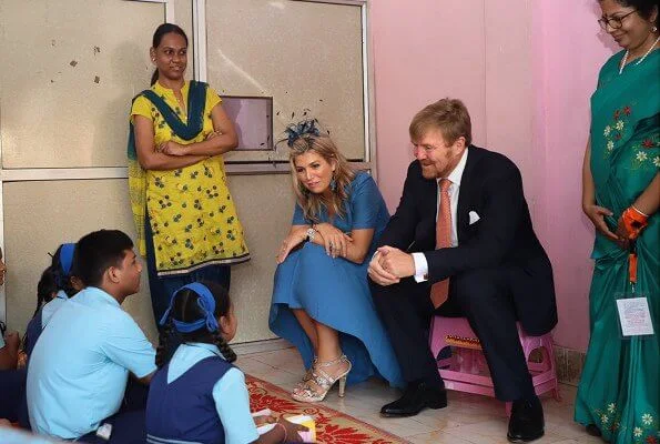 Queen Maxima wore Sandro blue ring detail midi dress. Queen Maxima wore a new turquoise green tulle dress by Natan