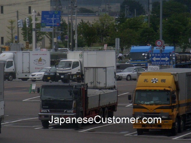 Japanese Trucks wait to board, Japan Copyright Peter Hanami 2014