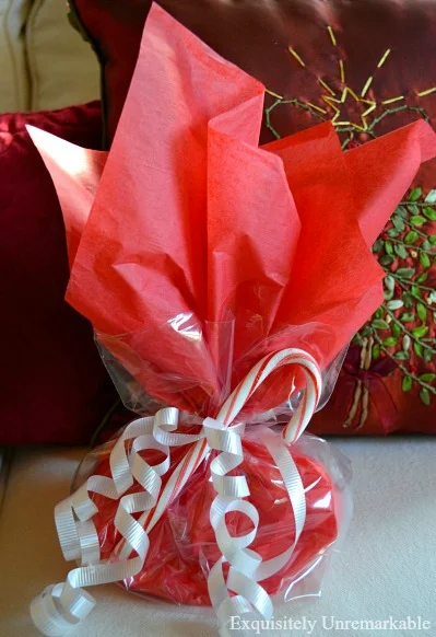 Red tissue paper and cellophane wrapped gift