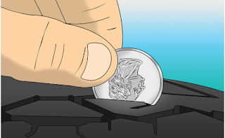 individual utilizing a quarter to check the tread on an auto tire 
