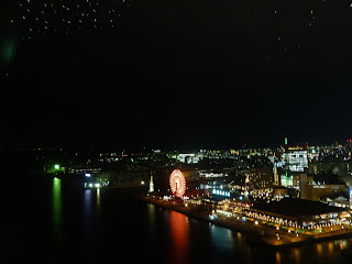 Lights and Ferris wheel of Harbour land reflected into the bay as seen from the Kobe Port Tower at night