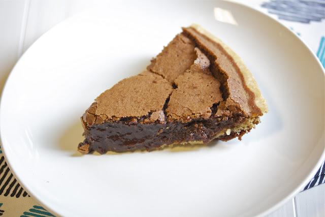 a slice of chocolate chess pie on a white plate