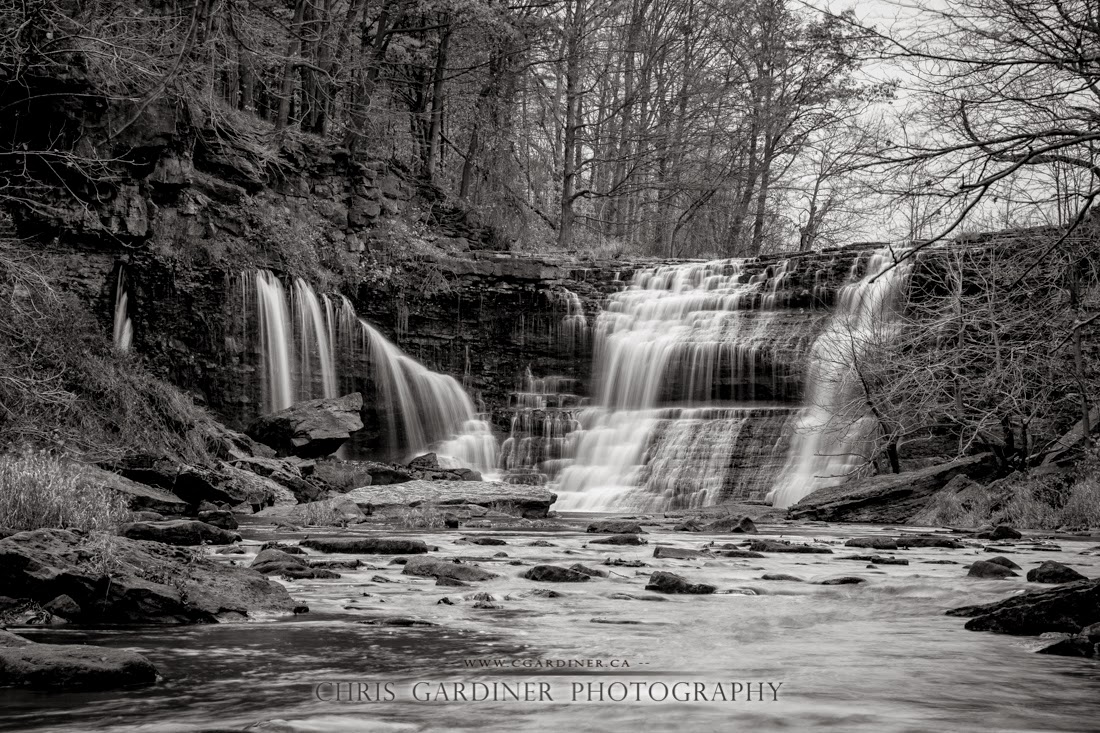 Scenic view in monochrome black and white of the Upper Balls Falls in southern Ontario along the Niagara Escarpment and Bruce Trail captured by Chris Gardiner Photography